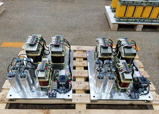 Internal component plates of passive harmonic filters with wired reactors and capacitors.