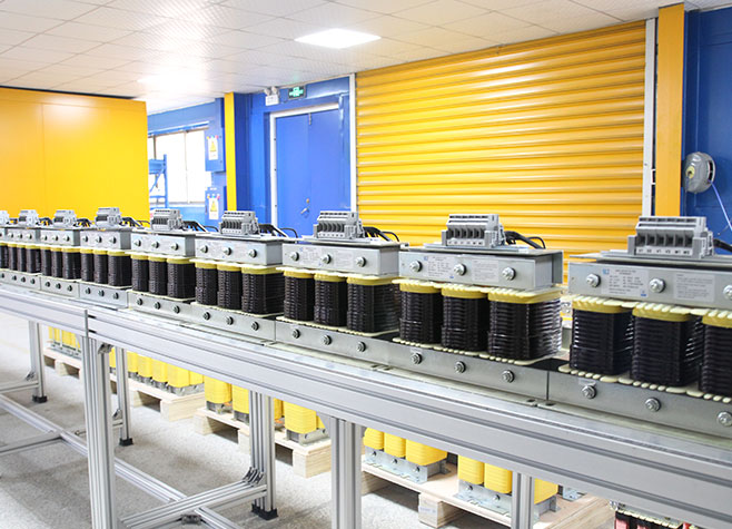 Mass production line of three-phase sine wave filters inside the LTECPower factory, demonstrating high-volume manufacturing capability.