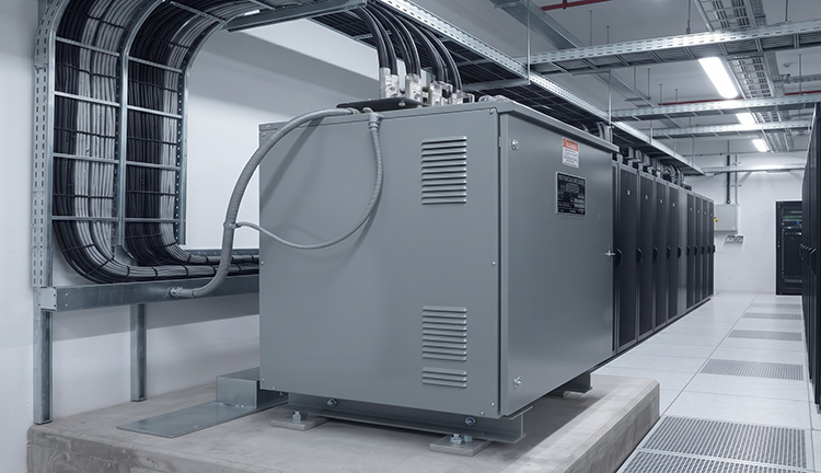 Dry-type transformer installed in a modern data center under IBC standards
