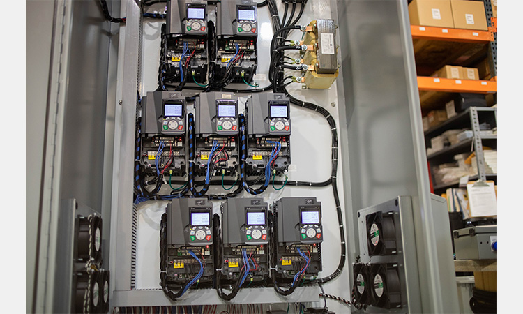 Industrial electrical control cabinet showing professional VFD and output reactor installation, wiring layout, and thermal management.
