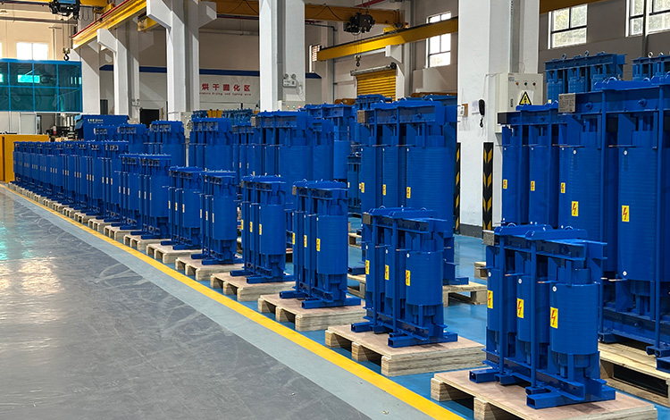 Batch of high-performance blue filter reactors neatly arranged in a modern factory workshop for industrial power quality applications.