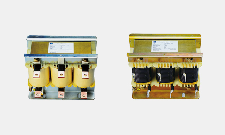 Side-by-side comparison of an input line reactor (left) and an output load reactor (right) used in VFD systems.