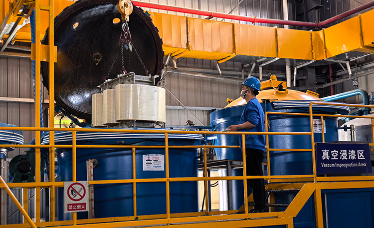 Transformer coils being loaded into the VPI vacuum pressure impregnation chamber