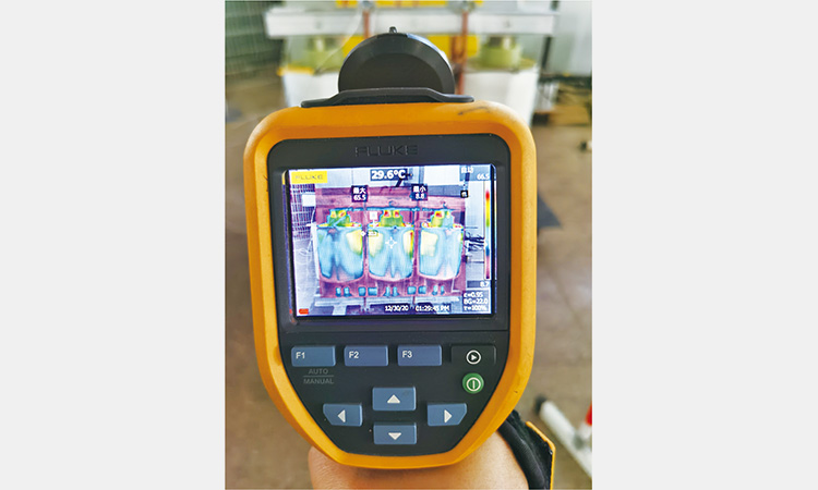 Using a thermal imaging device to monitor transformer winding temperature during testing.