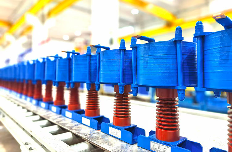 Manufacturing view of current limiting reactor coils and insulators in an industrial factory setting.
